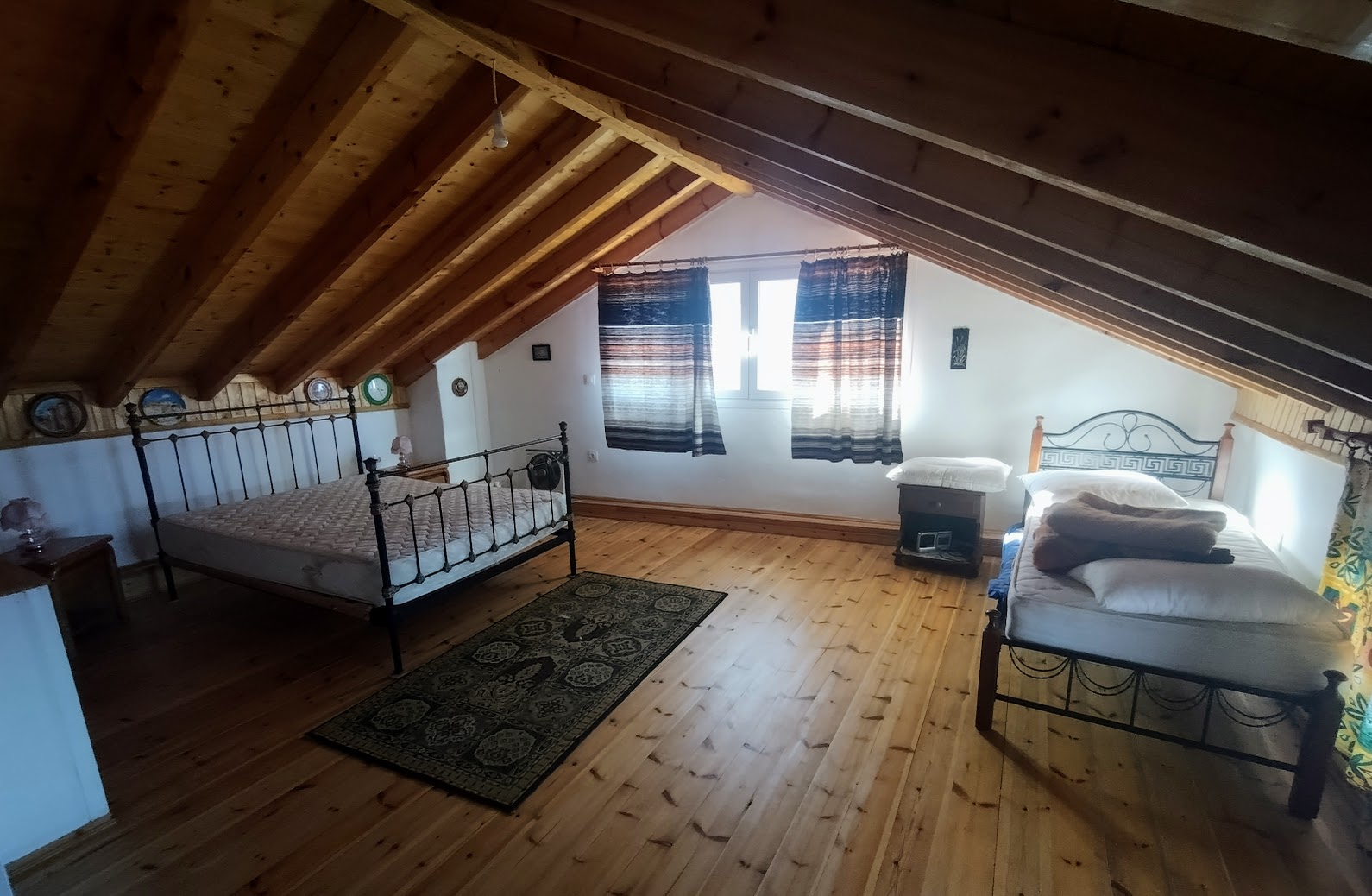 Traditional wooden-beamed bedroom in Ampelos village house